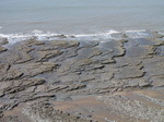 SX05166 Layers of rock slabs at beach.jpg